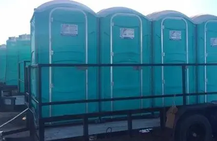 A row of portable toilets on top of a platform.